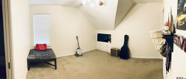 living area featuring light carpet, ceiling fan, and lofted ceiling