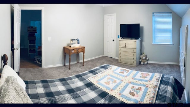 carpeted bedroom with lofted ceiling