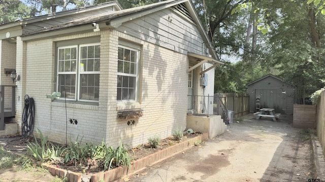 1012 W 8th St, Tyler, TX 75701 - view of property exterior featuring brick siding and an outbuilding
