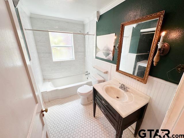1012 W 8th St, Tyler, TX 75701 - full bathroom featuring toilet, vanity,  shower combination, ornamental molding, and a wainscoted wall