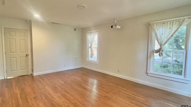 1012 W 8th St, Tyler, TX 75701 - spare room featuring wood finished floors and baseboards