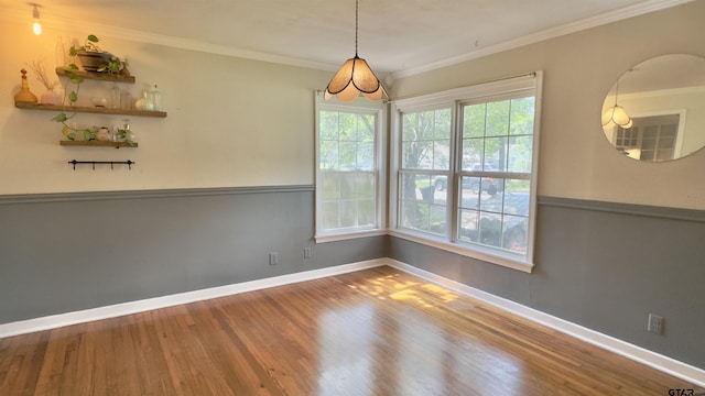 1012 W 8th St, Tyler, TX 75701 - unfurnished dining area with wood finished floors, baseboards, and crown molding