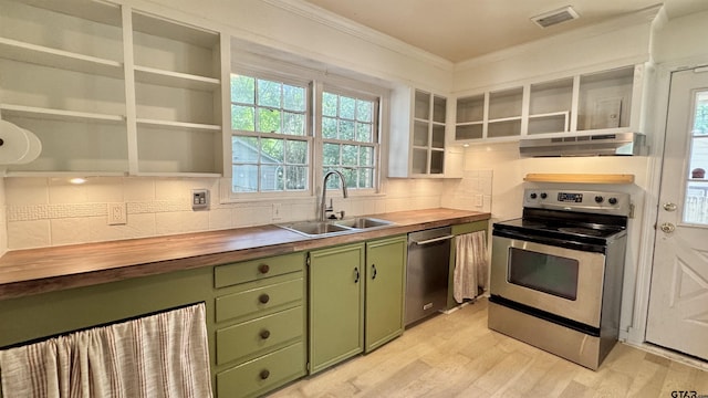 1012 W 8th St, Tyler, TX 75701 - kitchen featuring green cabinetry, butcher block counters, range hood, appliances with stainless steel finishes, and crown molding
