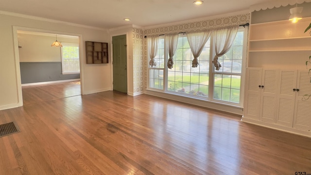 1012 W 8th St, Tyler, TX 75701 - unfurnished living room with ornamental molding, baseboards, wood finished floors, and recessed lighting