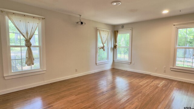 1012 W 8th St, Tyler, TX 75701 - unfurnished room featuring wood finished floors and baseboards
