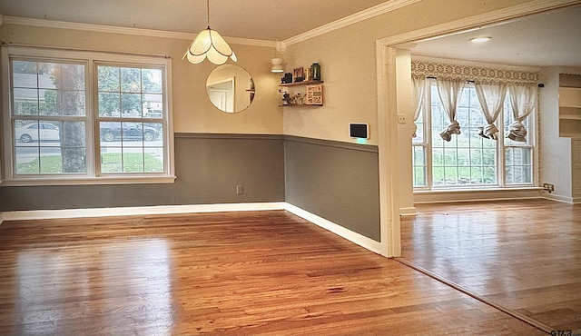 1012 W 8th St, Tyler, TX 75701 - unfurnished dining area featuring plenty of natural light, wood finished floors, baseboards, and ornamental molding