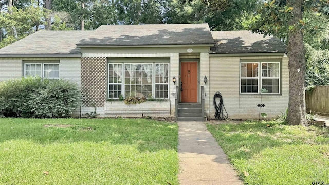 1012 W 8th St, Tyler, TX 75701 - view of front of home with brick siding and a shingled roof