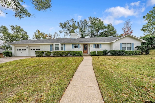 single story home featuring a garage and a front lawn