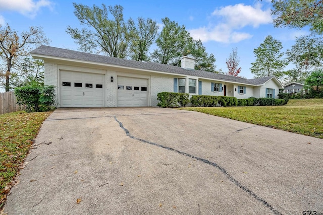 single story home featuring a front yard and a garage