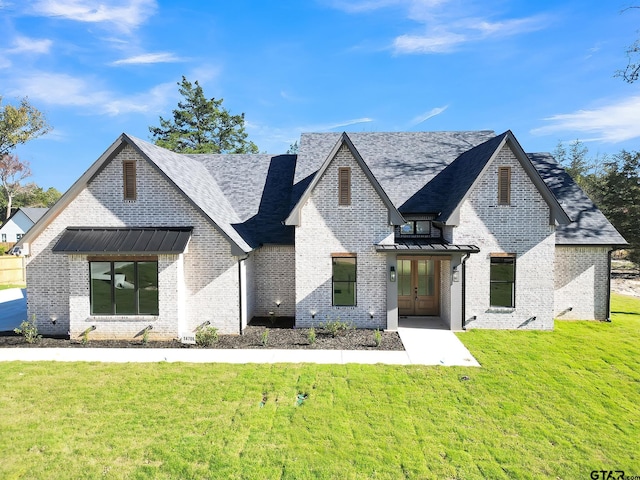 view of front of home featuring a front lawn and french doors