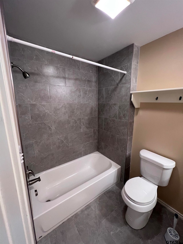 bathroom with toilet and tiled shower / bath combo