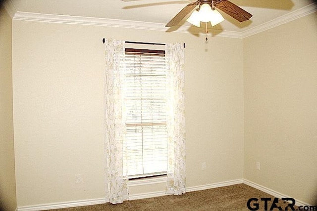 carpeted spare room featuring ceiling fan, ornamental molding, and baseboards