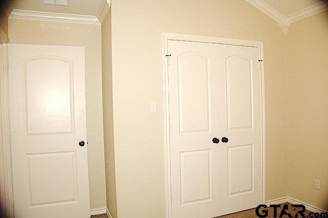 interior space with ornamental molding and baseboards