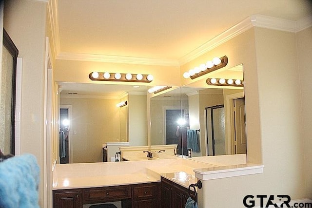 full bathroom with ornamental molding, a shower with shower door, and vanity