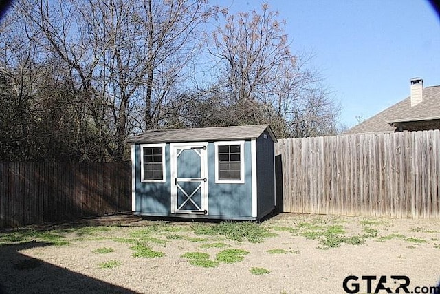 view of shed with a fenced backyard