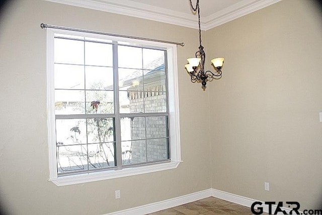 unfurnished room featuring a chandelier, a wealth of natural light, crown molding, and baseboards