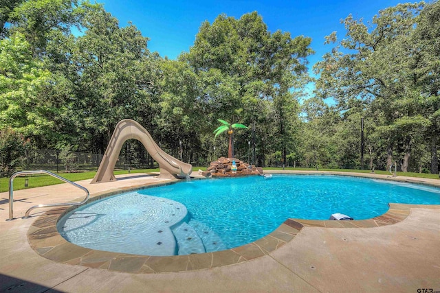 view of pool with a patio and a water slide