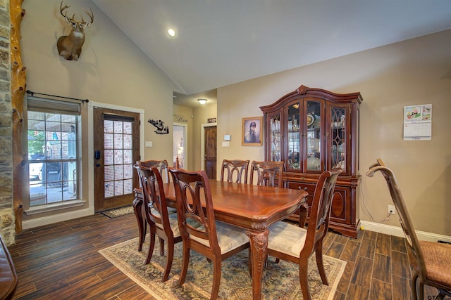 dining area with high vaulted ceiling