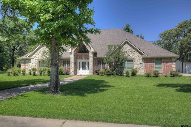 craftsman inspired home featuring a front lawn and french doors