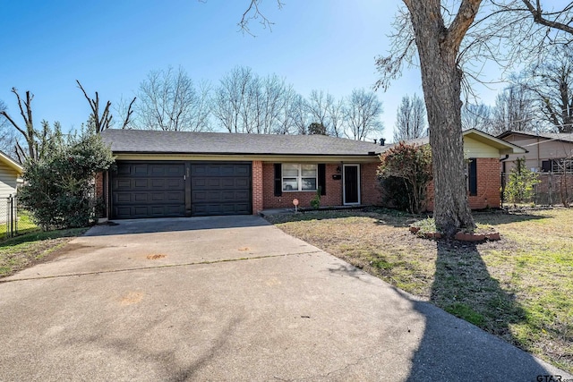 single story home with brick siding, concrete driveway, an attached garage, and fence