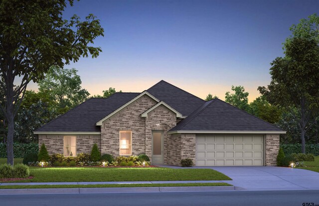 french country style house featuring a garage and a lawn