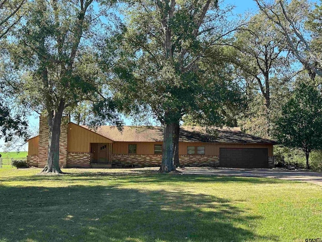 single story home with a garage and a front yard