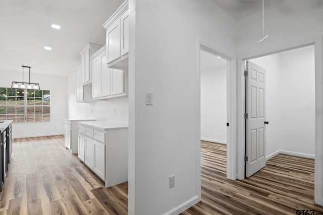 kitchen featuring dark hardwood / wood-style flooring and white cabinets