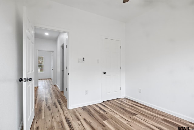 unfurnished bedroom featuring ceiling fan and light wood-type flooring