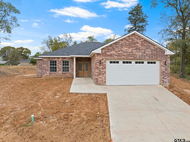 single story home featuring a garage and french doors