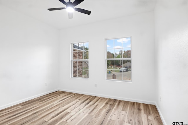 spare room featuring light wood-type flooring and ceiling fan