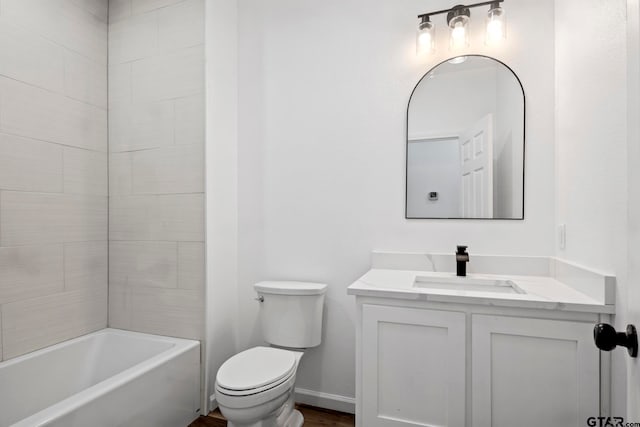 full bathroom featuring vanity, toilet, and tiled shower / bath combo