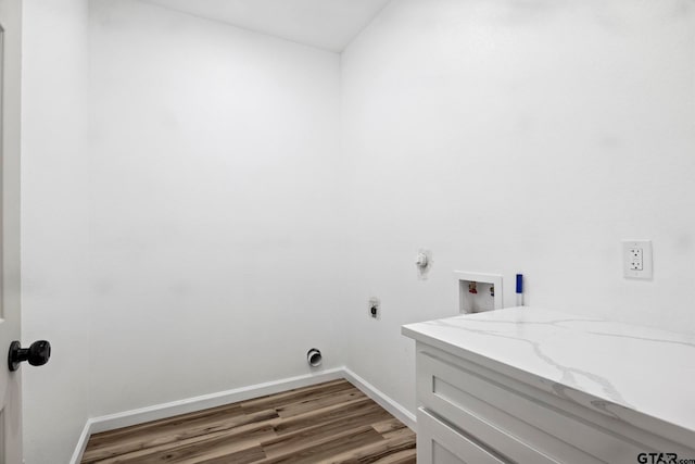 laundry area featuring cabinets, hookup for a washing machine, hardwood / wood-style flooring, and electric dryer hookup