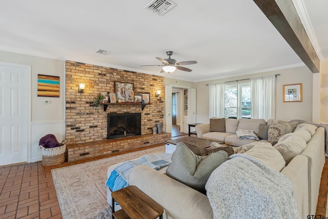 living room featuring a fireplace, ceiling fan, and ornamental molding