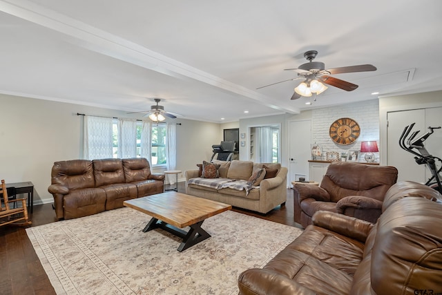 living room with dark wood-type flooring, ornamental molding, and ceiling fan