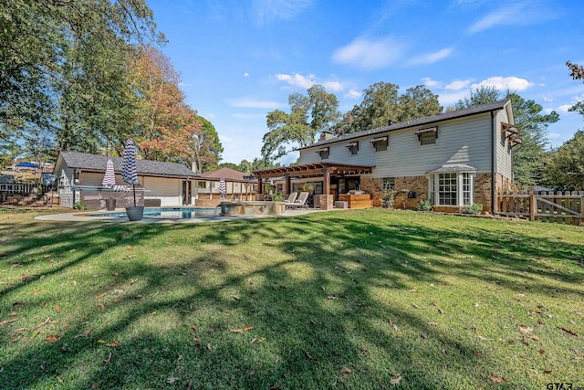 rear view of property with a yard and a patio area