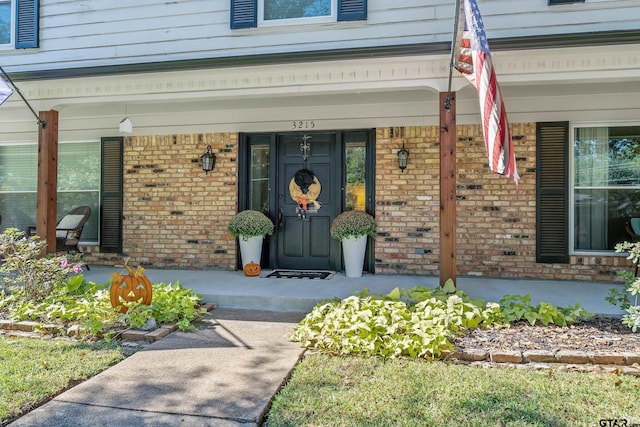 view of exterior entry with a porch