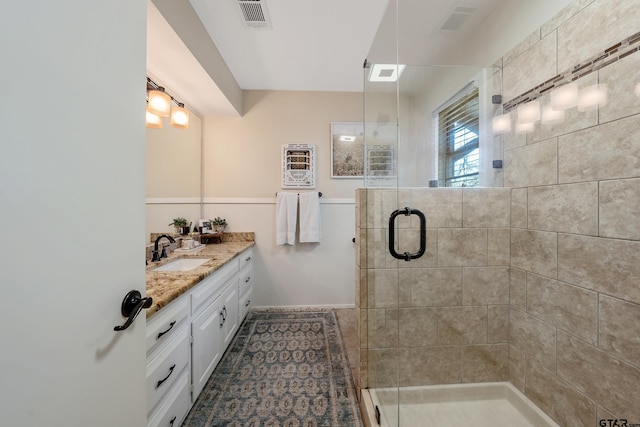 bathroom with walk in shower and vanity