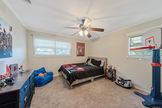 carpeted bedroom featuring ceiling fan and ornamental molding