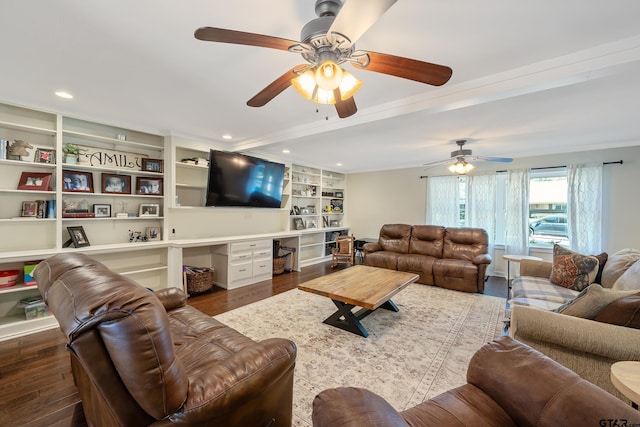 living room featuring dark wood-type flooring, ceiling fan, built in features, and crown molding