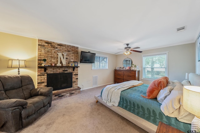 carpeted bedroom with a fireplace, ceiling fan, and ornamental molding