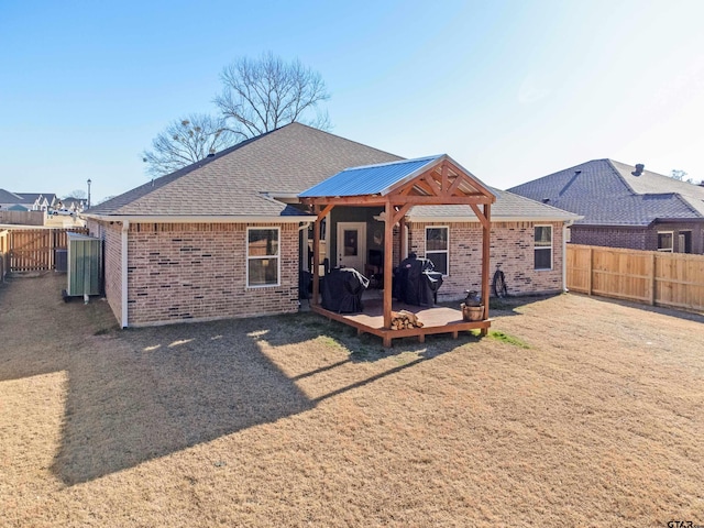 rear view of property with a wooden deck