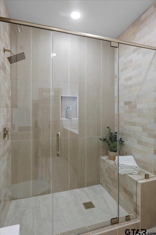 bathroom featuring a shower with shower door