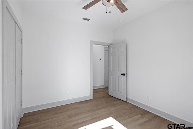 unfurnished bedroom featuring ceiling fan and light wood-type flooring