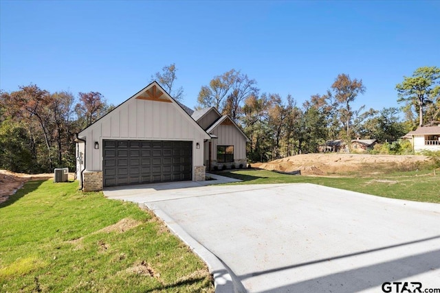 modern farmhouse style home with a front yard, a garage, and central air condition unit