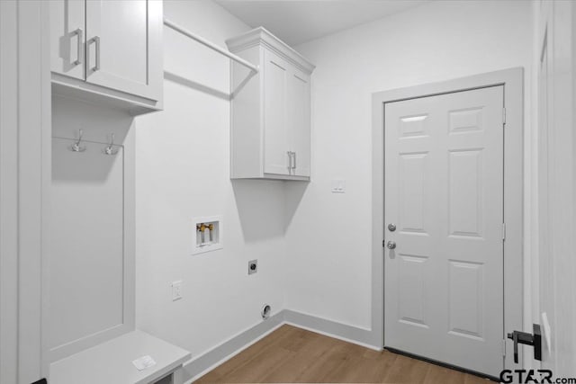 laundry area featuring hardwood / wood-style flooring, electric dryer hookup, cabinets, and washer hookup