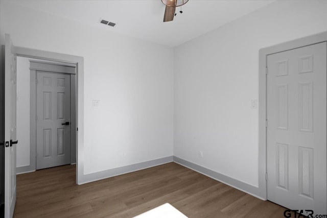 unfurnished bedroom with ceiling fan and light hardwood / wood-style flooring