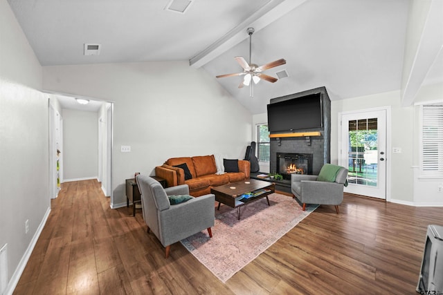 living room with dark hardwood / wood-style flooring, vaulted ceiling with beams, ceiling fan, and a fireplace