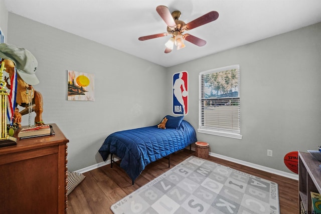 bedroom with dark hardwood / wood-style floors and ceiling fan