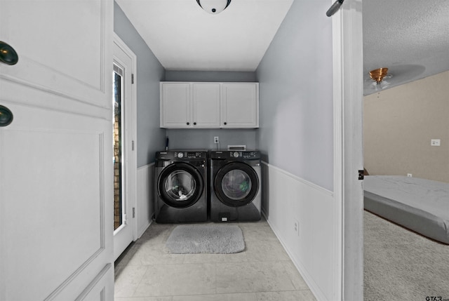 washroom with cabinets and separate washer and dryer