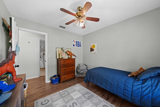 bedroom with dark hardwood / wood-style floors and ceiling fan